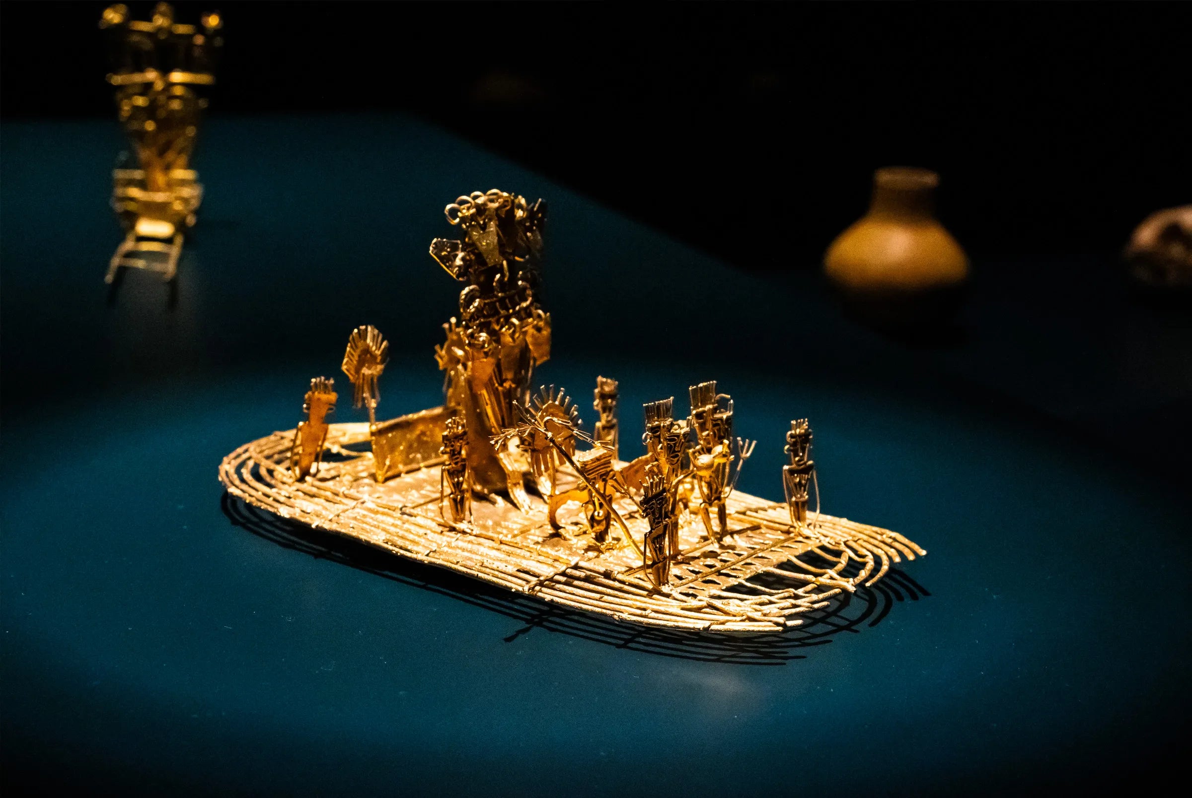 Golden Balsa Muisca raft depicting figures from the Muisca culture, an important pre-Colombian artifact displayed at the Gold Museum in Bogotá, Colombia.